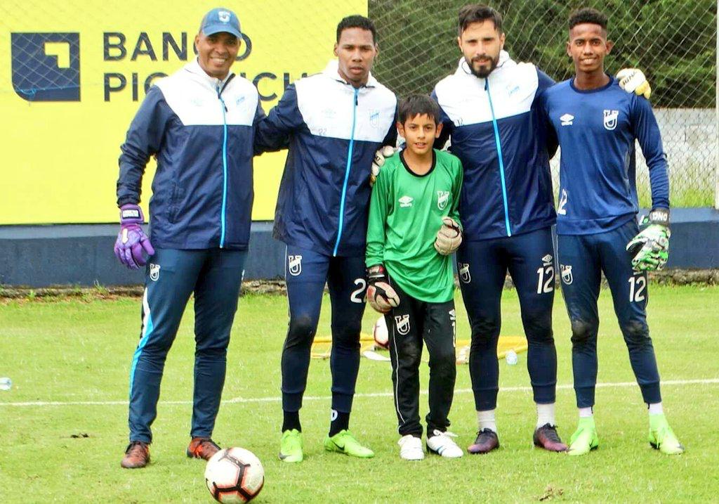 Group of youth and adult soccer goalkeepers posing together on the pitch, representing team spirit for the FIFA World Cup 2026.