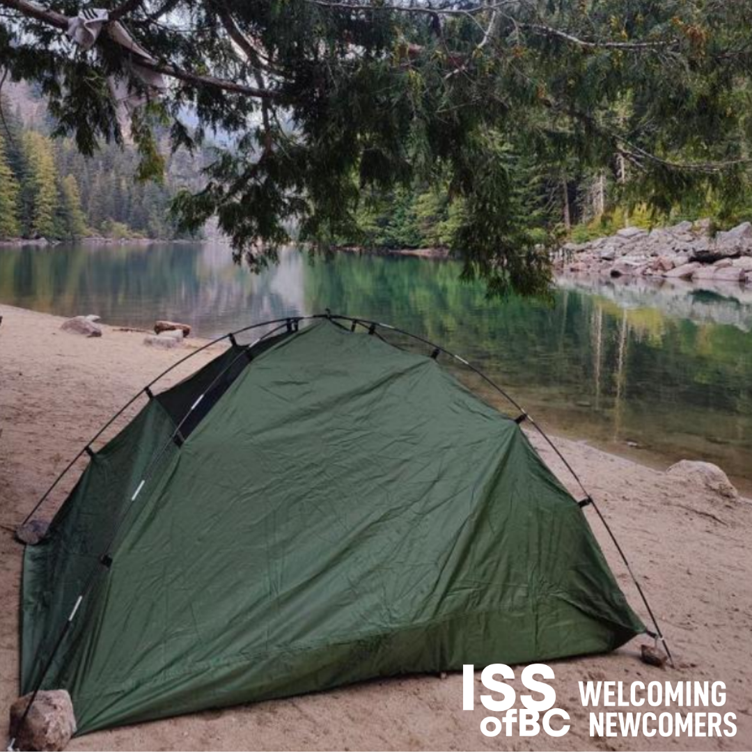 Green tent in the wilderness with the ISSofBC logo