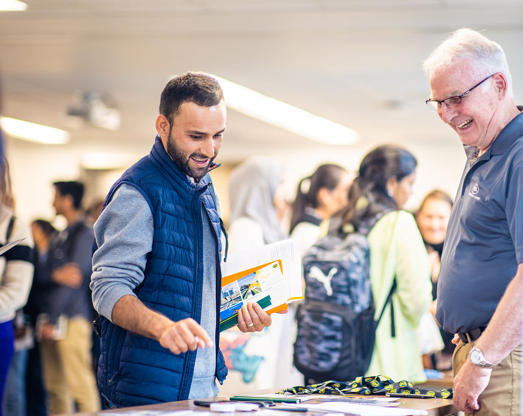 National Nonprofit Day. Young foreigner asked for guidance from a Canadian man.